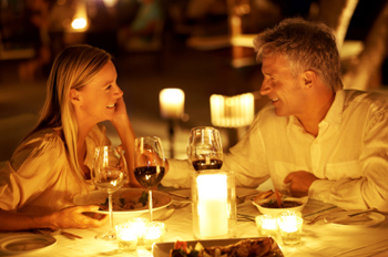 A young couple enjoying a romantic candlelight dinner at restaurant