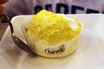 a round scoop of yello (lemon9 ice cream in cupcake paper