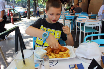 our 8 year old son squeezing lemon juic eon his fish and chips