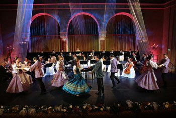 dancers and a music orchestra on stage in the Vigado's concert hall