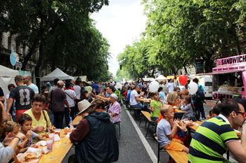 lots of people sitting at wooden tables on Andrassy on the Street Food show