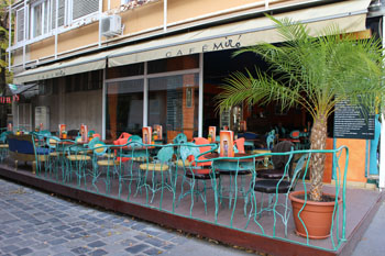 green metal chairs and tables on the terrace of Cafe Miró