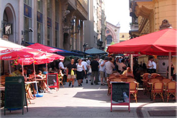 terraced restaurants with red tents on both sides of the Raday street