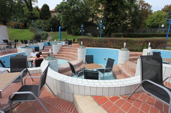 small garden tables and chairs in the empty children pools at Pagony