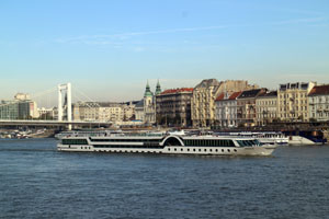A large, white tour boat on the Danube, near Erzsebet bridge