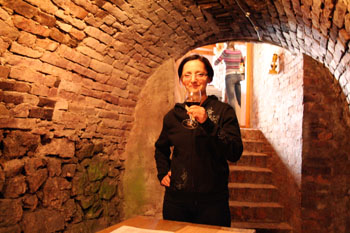 me sipping wine in a vualted stone cellar in Villany