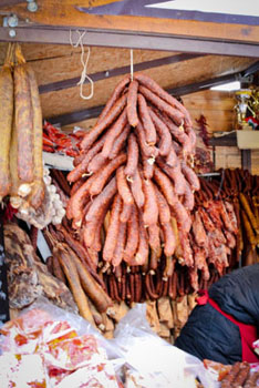 sausages hanging from the beams of a wooden cottage