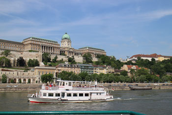 a whiet sightseeing boat on the Danube at Buda castle