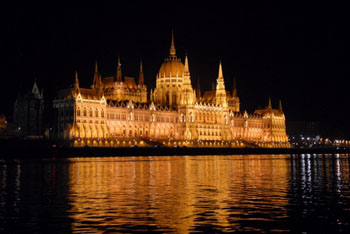 the front facade of the Parliament illuminated at night