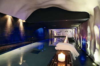 the swimming pool a lighted candle and a white bathrobe