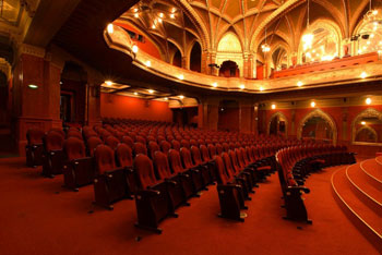 red plush seats of the theatre hall of the Urania Cinema