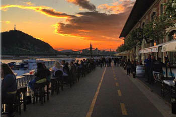 people sitting at the terrace of the Balna at dusk