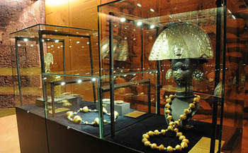 gold and other artefcats in a glass cabinet