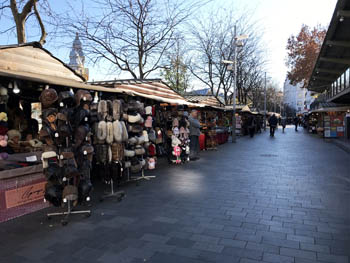 wooden cottages selling fur hats and other stuff next to the square