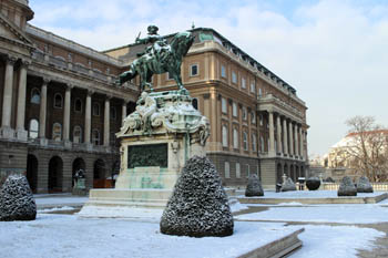 an equestrian bronze statue at one of the terraces of the Royal Palace in winter
