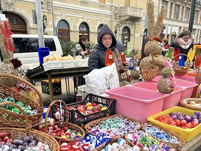 colorful painted Easter eggs wicker baskets and a large wicker bunny at a seller on Hunyadi Square market