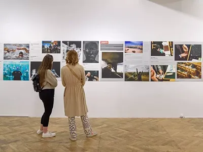 two women viewing the photos exhibited on the Press Photo Exhibition