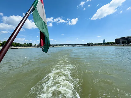the stern water and part of the Hungarian Nationa Flag - photograhed on the Kisfaludy boat in late spring