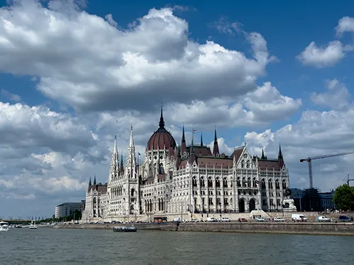 the Parliament building photographed from a cruise boat on a cloudy spring day