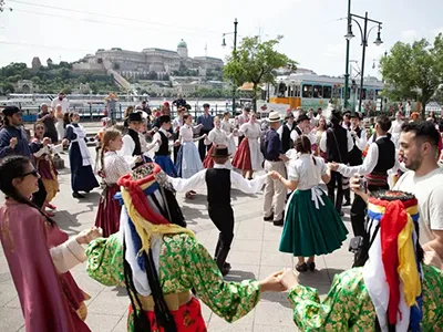 flash mob featuring folk dancers in costume performing on the Danube Promenade during the Danube carnival in June 2024