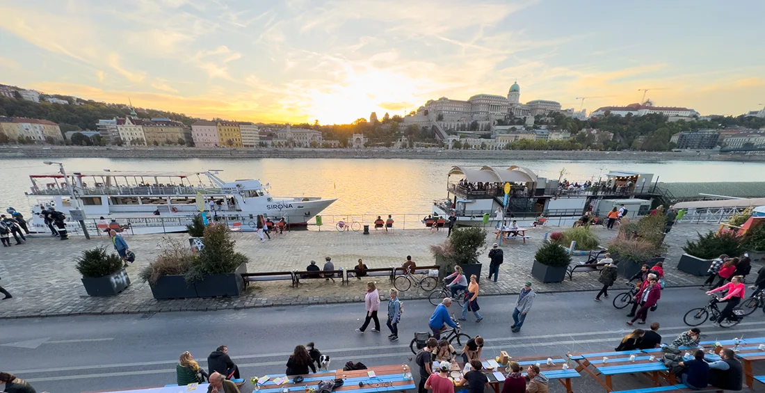 Sunset sightseeing cruise on the Danube River in Budapest with warm evening light reflecting on the water and the city’s historic skyline in view.